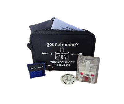 A black zippered pouch labeled “got naloxone? Opioid Overdose Rescue Kit” contains a nasal spray device, a small CPR face shield in a blue case, an instruction sheet, and a round button with text: “To Save Lives.”.