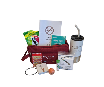A red zippered pouch labeled My Quit Kit contains a journal, colored pencils, gum, a water bottle with a metal straw, mints, a beaded key ring kit, lip balm, a stress stick, and a hair tie, all arranged neatly on a white background.